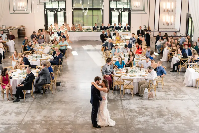 First dance under the barn’s high ceiling, full reception around it