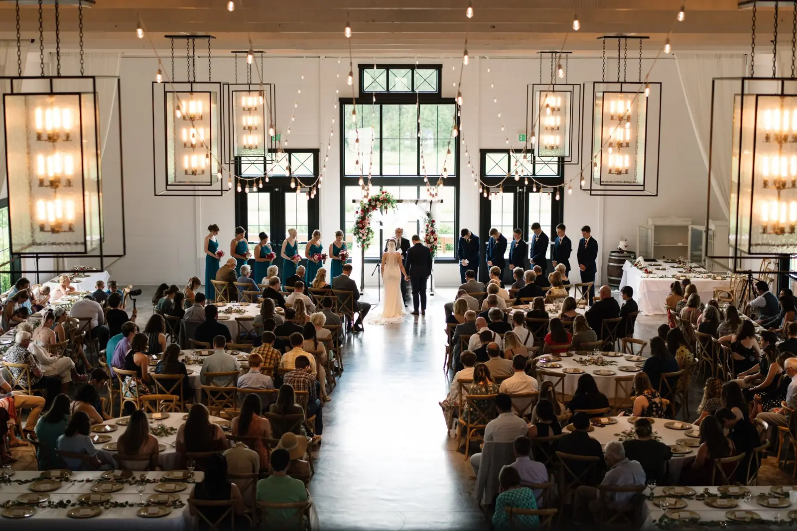 An indoor ceremony, the hall packed with guests