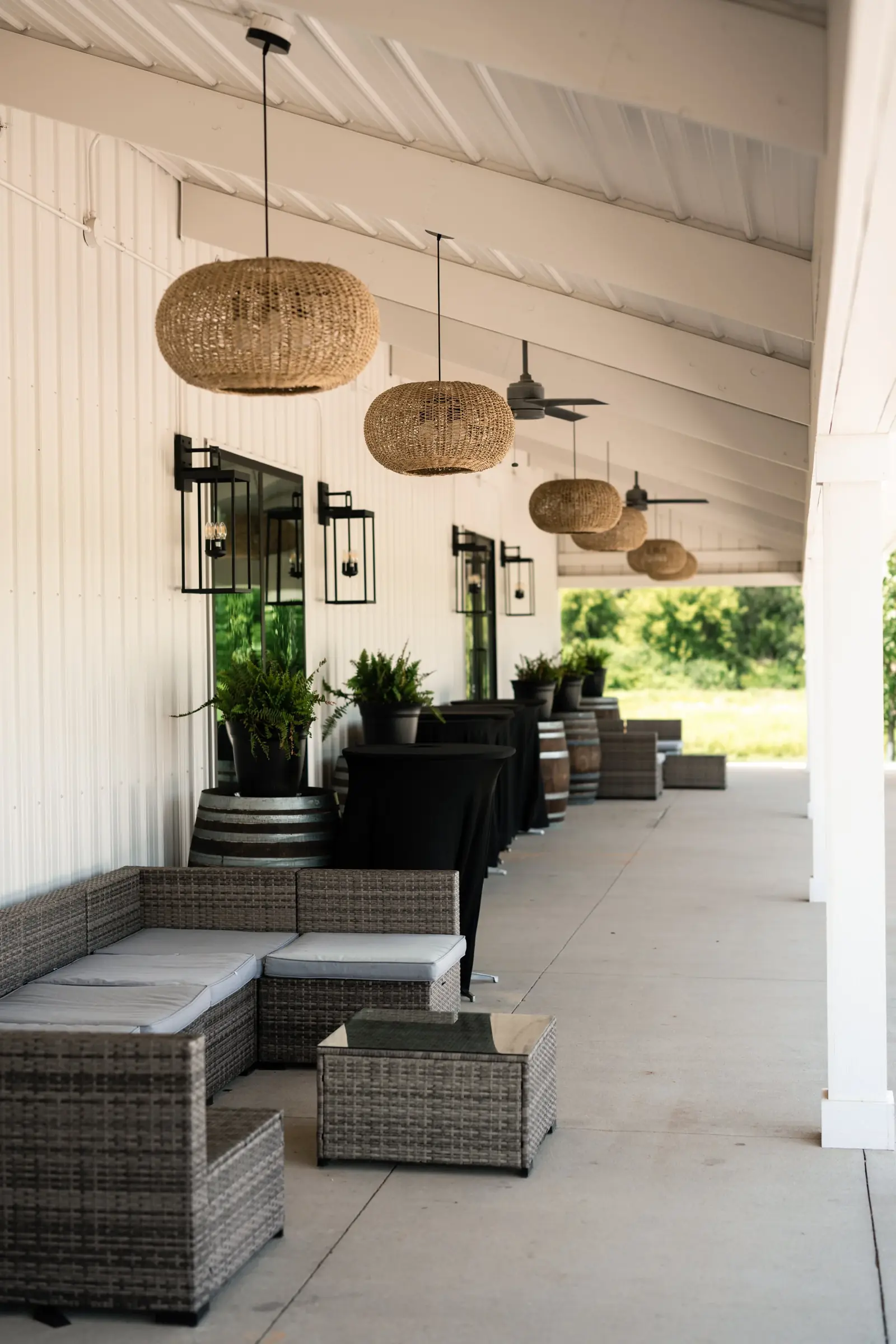 The covered veranda with bistro lights and lounge seating
