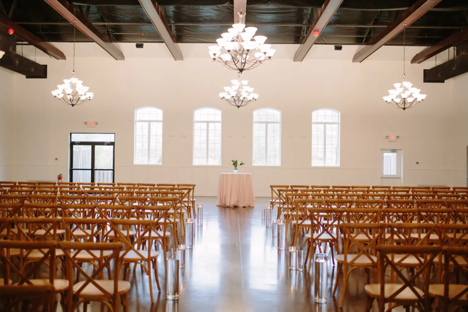 Chandeliers and arched windows along the hall