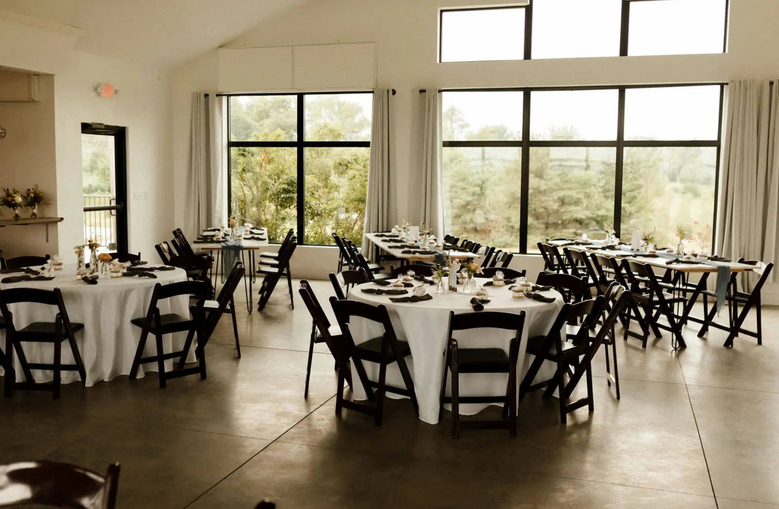 The main hall set for dinner, walls of windows