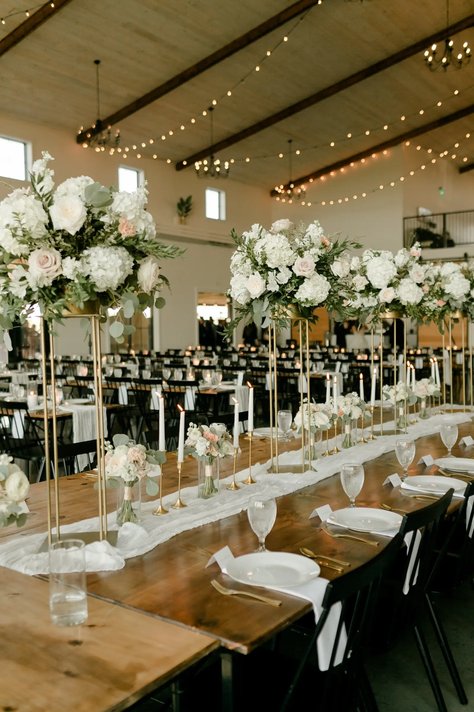 Tall floral centerpieces down the hall