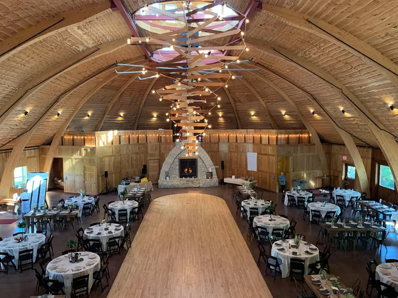 Inside the Double Round barn — the timber dome, set for dinner