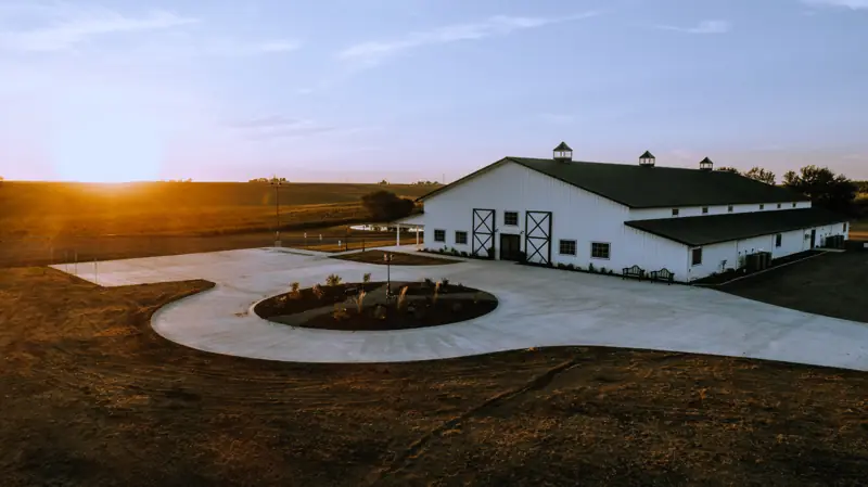 The white barn and its circle drive at sunset