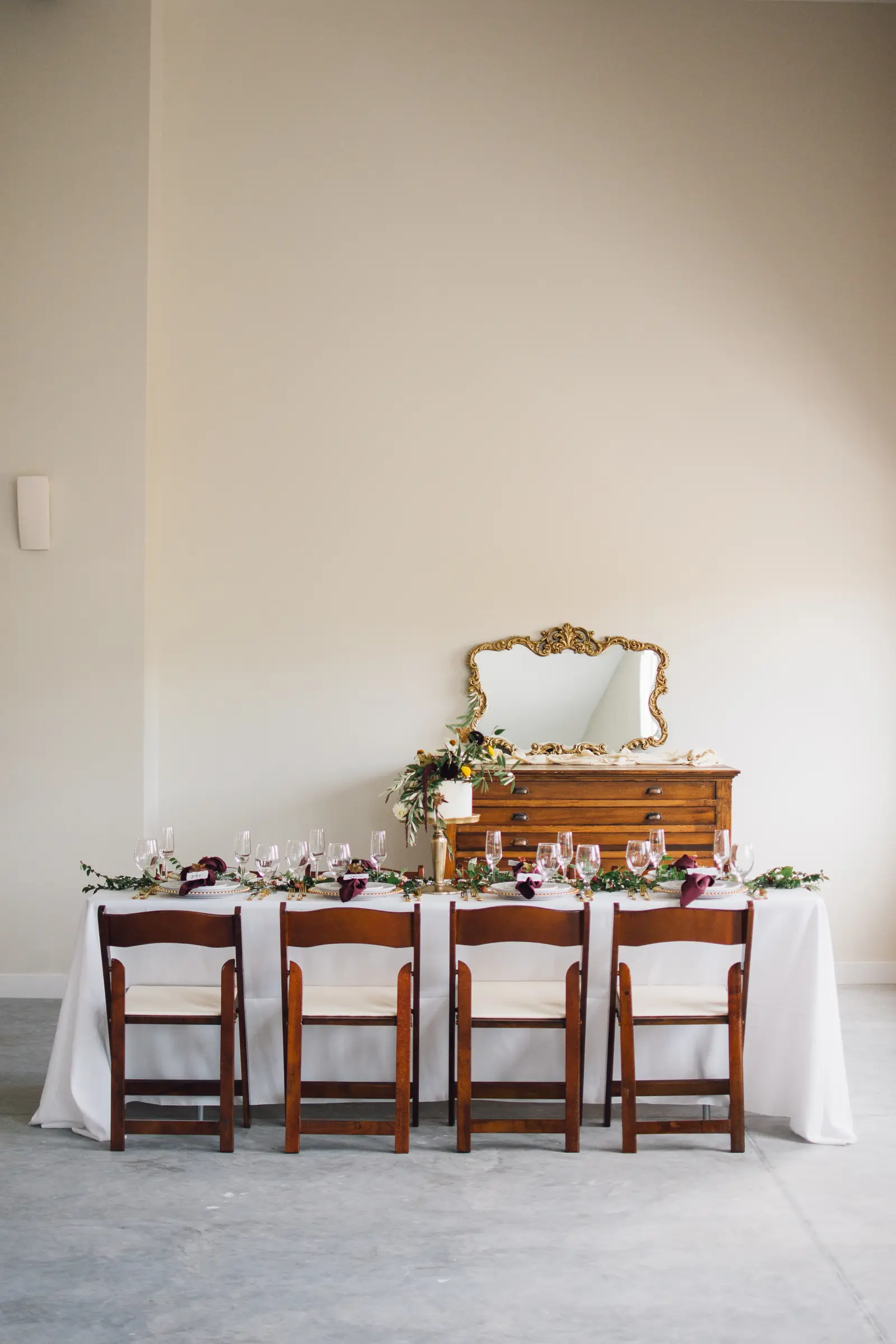 The head table in front of the gold mirror
