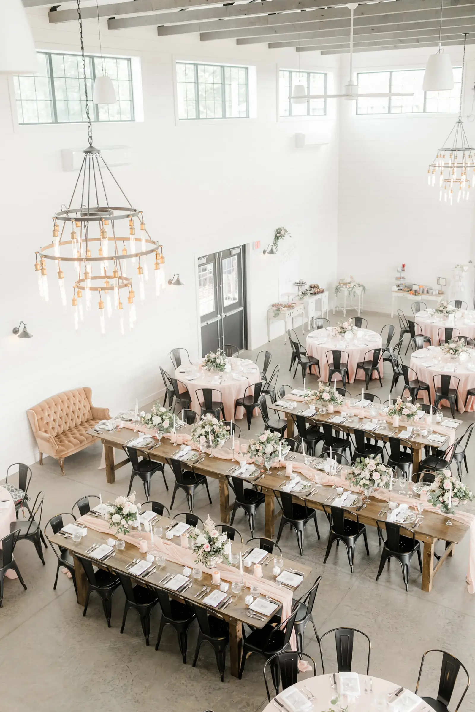 The indoor hall set for dinner, chandeliers overhead