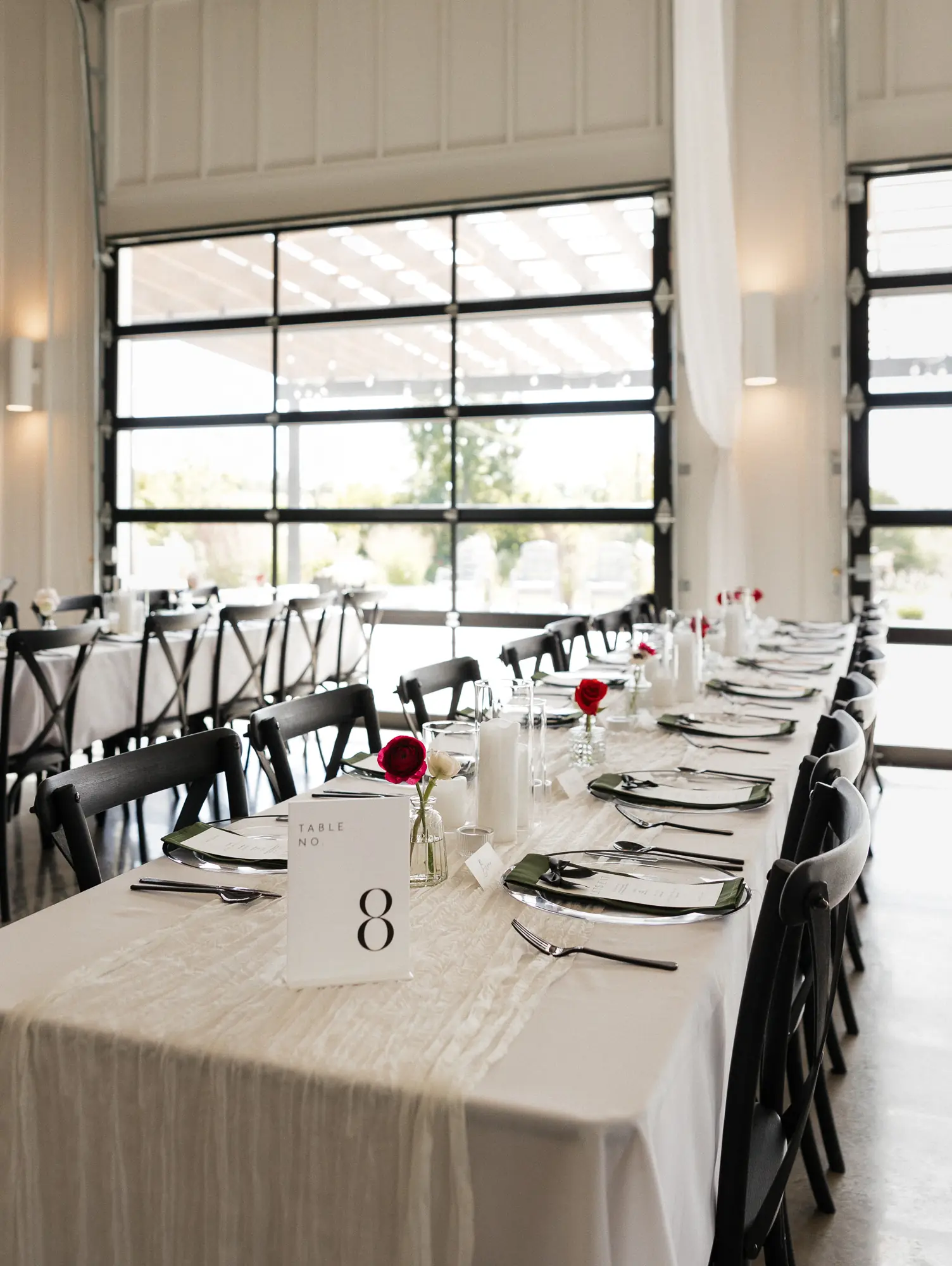 Long tables by the glass garage doors