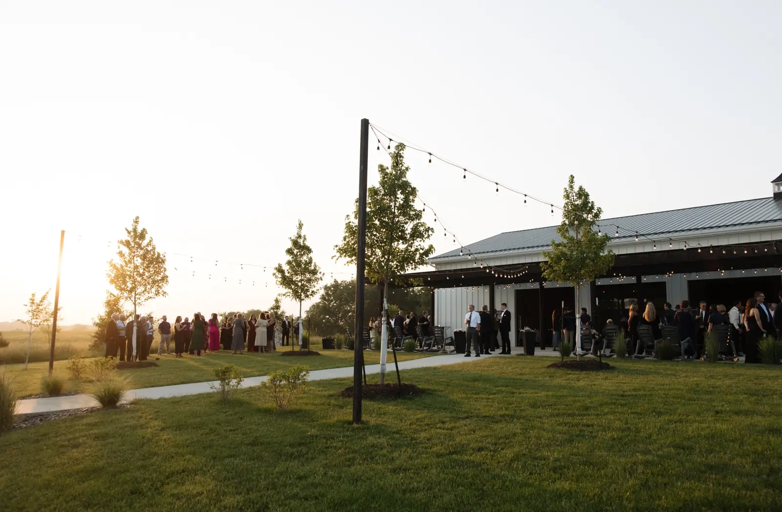 The covered patio full of guests at golden hour